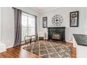 Living room features fireplace, hardwood floors, and built-in shelving at 1046 Island Pointe Dr, Winter Garden, FL 34787