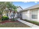 House exterior featuring walkway, landscaping, and palm trees at 2003 Rocky Pointe Dr, Lakeland, FL 33813