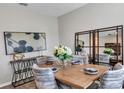 Elegant dining room with wood table and statement mirror at 3141 Zuni Rd, St Cloud, FL 34771