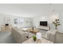 Bright living room features neutral walls, plush carpet, and contemporary furniture for a cozy and inviting space at 1622 Ruby Ln, Lake Alfred, FL 33850