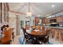 Bright dining room with an oval wooden table and chairs at 4680 Poinciana Dr, Indian Lake Estates, FL 33855