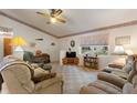 Cozy living room with comfortable seating and large windows at 4680 Poinciana Dr, Indian Lake Estates, FL 33855
