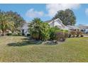 Beautiful home with lush landscaping, palm trees, and a well-manicured lawn at 515 Torres Pl, Lady Lake, FL 32159