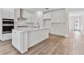 White kitchen with an island and stainless steel appliances at 6809 Sw 90Th Loop, Ocala, FL 34476