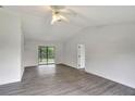 Open living room with gray vinyl flooring and sliding glass doors at 10420 Vista Del Sol Cir, Clermont, FL 34711