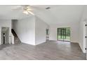 Bright living room with gray vinyl flooring and sliding glass doors at 10420 Vista Del Sol Cir, Clermont, FL 34711