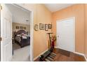 Bright entryway with hardwood floors and a view into a bedroom at 1504 Fort Meade Pl, Poinciana, FL 34759