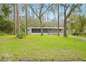 Mobile home with large yard surrounded by tall trees at 2519 State Park Rd, Lakeland, FL 33805