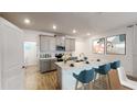 Modern kitchen with gray cabinets, quartz countertops, and teal barstools at 1922 Rider Rain Ln, Apopka, FL 32703