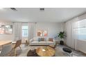 Bright living room featuring a light beige sofa and coffee table at 1922 Rider Rain Ln, Apopka, FL 32703