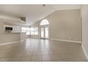 Bright living room with tile flooring, a high ceiling and an adjacent open-concept kitchen at 2504 Davenport Cir, Kissimmee, FL 34746