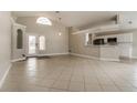 Bright living area with tile flooring, high ceilings, and an open floor plan connecting to the kitchen at 2504 Davenport Cir, Kissimmee, FL 34746