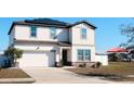 Two-story house with solar panels, white siding, and a two-car garage, plus playground view at 430 Stillwater Ln, Haines City, FL 33844