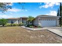 One-story home showcasing a two-car garage and nicely landscaped front at 1371 Laurel Glen Dr, Bartow, FL 33830