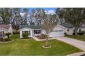 Single-story house with a two-car garage and spacious yard at 1309 Ballesteros Dr, The Villages, FL 32162