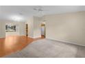 Spacious living room with hardwood and carpeted floors, ceiling fan at 1309 Ballesteros Dr, The Villages, FL 32162