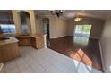 Spacious living room with laminate flooring and sliding glass doors at 30132 Pga Dr, Sorrento, FL 32776