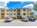 Exterior view of condo building showcasing landscaping and parking at 3036 Parkway Blvd # 206, Kissimmee, FL 34747