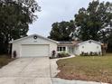 Newly renovated home with a modern exterior and solar panels at 605 Aldama Ct, Ocoee, FL 34761