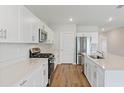 Modern kitchen with white cabinets, stainless steel appliances and an island at 2204 Canyon Oak Dr, Davenport, FL 33837