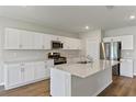 Modern kitchen with white cabinets, stainless steel appliances and an island at 2204 Canyon Oak Dr, Davenport, FL 33837