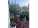 Beautiful landscaping with vibrant flowers, mature trees, and neatly arranged mulch at 113 Walton Heath Dr, Orlando, FL 32828