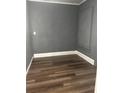 Small bedroom with grey walls and wood-look flooring at 1112 W 12Th St, Lakeland, FL 33805