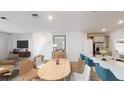 Bright dining area with light wood table and chairs, adjacent to kitchen at 4154 Jespersen St, Apopka, FL 32712