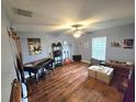 Spacious living room featuring wood floors, ceiling fan, and ample space for instruments at 2157 Geneva Dr, Lakeland, FL 33805