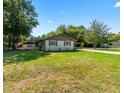 Ranch style home with a well-manicured lawn at 5018 Se 106Th Pl, Belleview, FL 34420