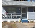 Quaint house exterior, featuring a blue-painted front and porch at 1268 Cr 436, Lake Panasoffkee, FL 33538