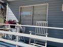 Quaint front porch with rocking chair and small table at 1268 Cr 436, Lake Panasoffkee, FL 33538