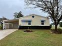 Single story home with carport, awning, and well-manicured lawn at 3109 Sand Trap Ct, Lakeland, FL 33810