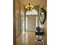 Bright entryway with a chandelier, mirror, and tile flooring at 619 Parakeet Ct, Kissimmee, FL 34759
