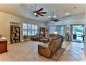 Bright living room with high ceilings and two ceiling fans at 706 Lake Diamond Ave, Ocala, FL 34472