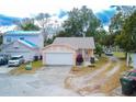 Nice peach house with a white garage door and landscaping at 1100 Lowry Ave # 7, Lakeland, FL 33801