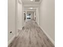 Bright hallway with wood-look flooring leading to other rooms at 13881 Rushing Creek Run, Orlando, FL 32824