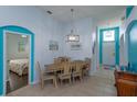 Dining room with light wooden table and six chairs, teal walls at 2254 Wyndham Palms Way, Kissimmee, FL 34747