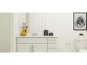 Modern bathroom with white vanity, toilet, and framed art at 692 Bald Cypress Dr, Lakeland, FL 33801
