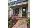 Inviting front porch with brick flooring and a cozy porch swing at 4035 Solamor St, Lakeland, FL 33810