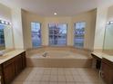 Large bathroom with a garden tub and dual vanities at 2912 Sweetspire Cir, Kissimmee, FL 34746