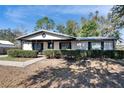 House exterior with a covered porch and neatly trimmed hedges at 613 4Th Ne St, Fort Meade, FL 33841