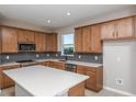 Modern kitchen featuring stainless steel appliances, a center island, and wooden cabinets at 8707 Sw 57Th Ln, Ocala, FL 34481