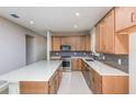 Modern kitchen featuring stainless steel appliances, a center island, and wooden cabinets at 8707 Sw 57Th Ln, Ocala, FL 34481