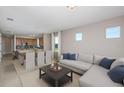 Inviting living room and dining area featuring neutral tones and comfortable seating near the modern kitchen at 8707 Sw 57Th Ln, Ocala, FL 34481