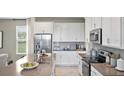 Modern kitchen with white cabinets and gray countertops at 1848 Bright Sky Dr, Kissimmee, FL 34744