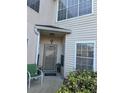 Front entrance with a small patio and green chair at 2948 W Cottage Grove Ct # Ge, Orlando, FL 32822