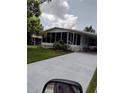 Front view of a manufactured home with a screened porch at 2628 Mcdaniel Dr, Kissimmee, FL 34758