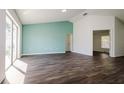 Spacious living room with dark hardwood floors and a wall of windows at 3088 Sire Trl, Lakeland, FL 33811
