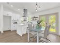 Bright dining area with glass table and chairs, adjacent to the kitchen at 1875 S Merrick Dr, Deltona, FL 32725